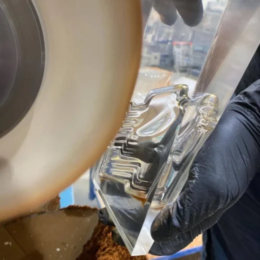 Midton craftsman polishing premium cast acrylic award during UK custom awards manufacturing process.
