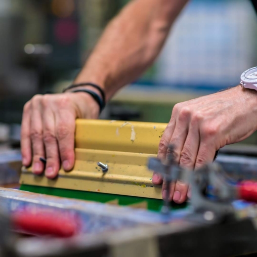 Screen printing branding onto bespoke awards during custom award production in the UK.