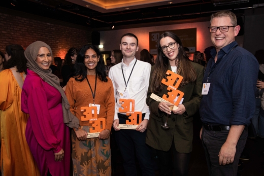 5 people standing with 3 sustainable awards