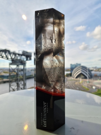 image of the scottish influencer award, made from sustainable manufacturing processes in front of the Clyde in glasgow. 