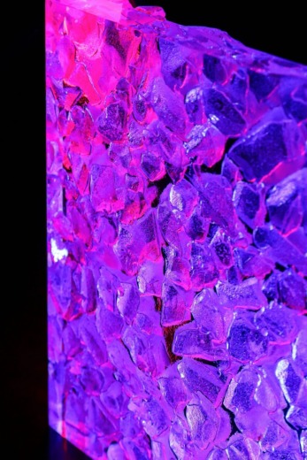 cast acrylic recycled chips on a clear acrylic sheet with translucent pink and purple light