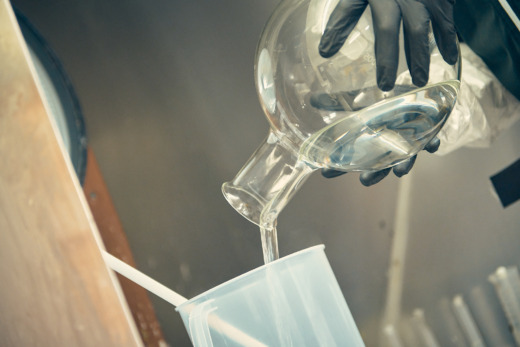 Cast acrylic monomer poured into a container using scales