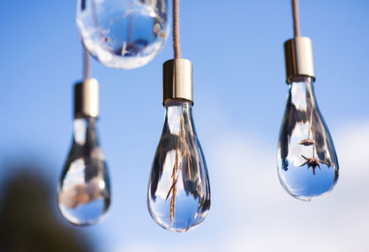 Clear cast acrylic light droplets with flowers encapsulated hanging on rope
