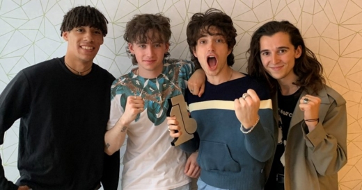 4 people standing holding a number 1 sustainable awards