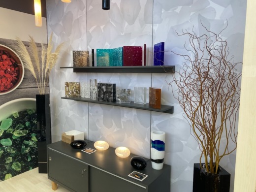 Show stand with vases, plants, lights and range of coloured acrylic plaques