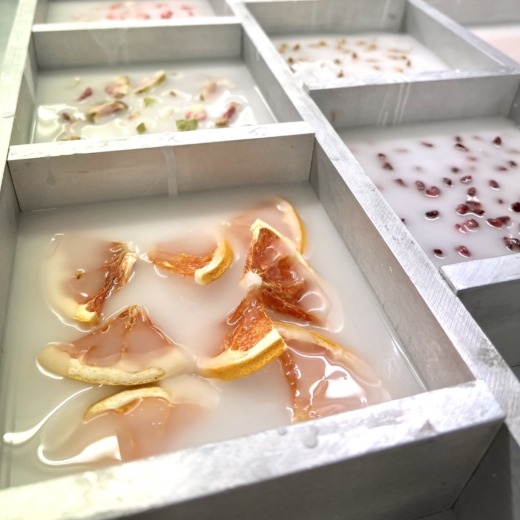 fruits and botanicals embedded in clear acrylic with an aluminium mould for corporate gifts