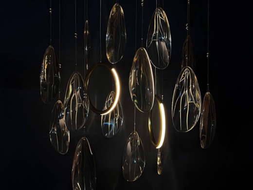 Clear acrylic and brass bespoke lighting droplet chandelier on a black background