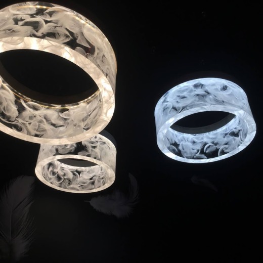 Three feather ring lights illuminated on a black background for acrylic fabrication