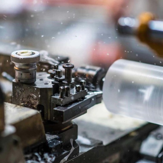 CNC Lathe turning a clear acrylic cylinder for acrylic fabrication