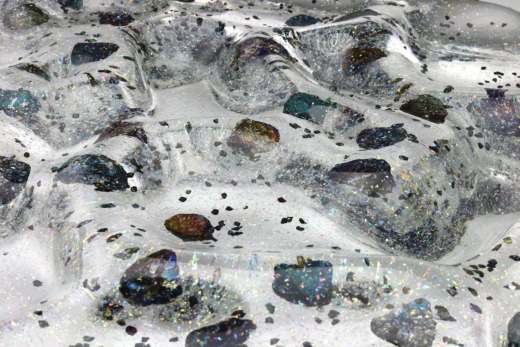 Clear acrylic wave panel with glitter and rocks encapsulated for custom materials
