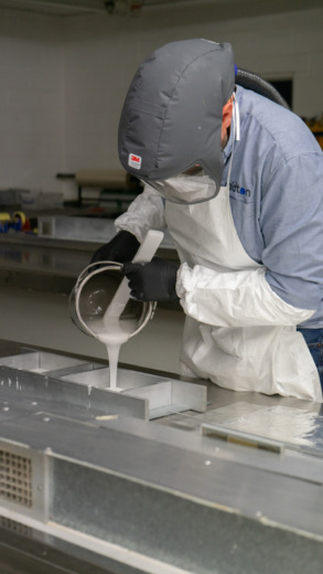 Cast acrylic operator pouring acrylic in metal moulds for commemorative gifts