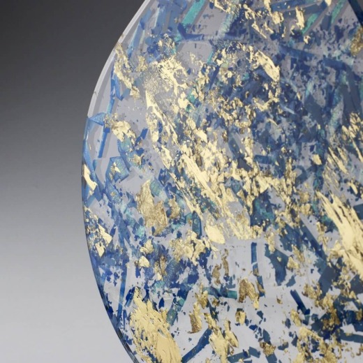 Clear acrylic disc with gold leaf and blue ribbon encapsulated for custom materials