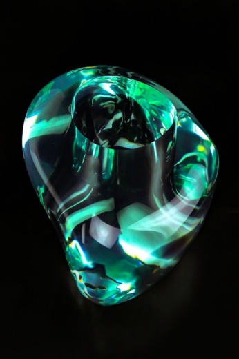 Translucent green pebble with a large hole machined for movie props