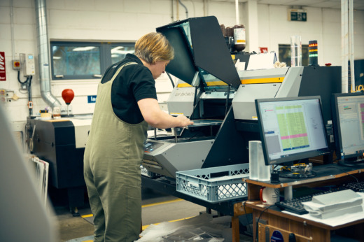 Print operator setting up a print bed for commemorative gifts