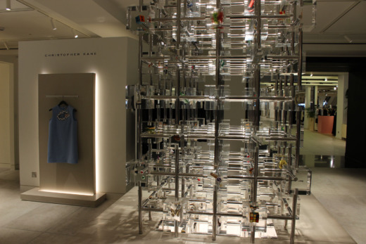 Christopher Kane product displays in a retail clothes shop. clear acrylic cubes with metal grid connectors