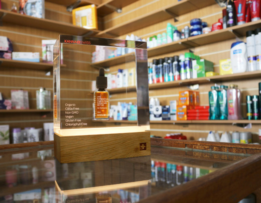 Kana Swiss clear acrylic and wooden LED illuminated bottle product displays in a chemist shop