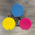 Three coloured recycled acrylic stools on a wooden floor