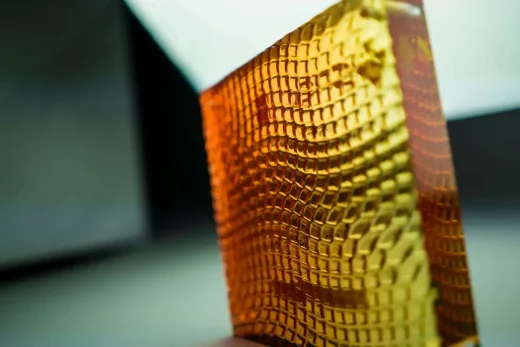 Translucent orange and yellow acrylic square custom materials panel with machined texture on the back
