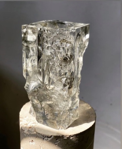 Clear acrylic custom materias carved vase on a stone cylinder base