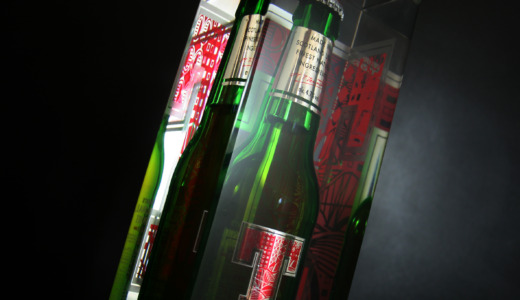 Tennent's bottle glorifiers with a Tennent's bottle embedded in clear acrylic on a black background