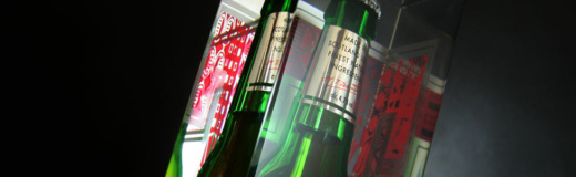 Tennent's bottle glorifiers with a Tennent's bottle embedded in clear acrylic on a black background