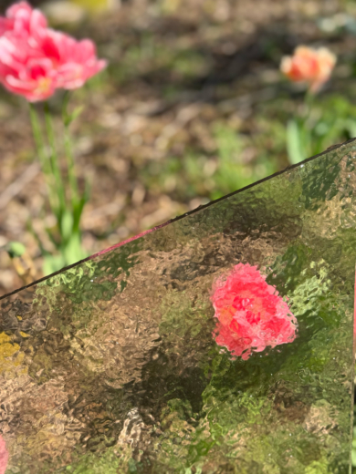 brut panel with flower garden in the background