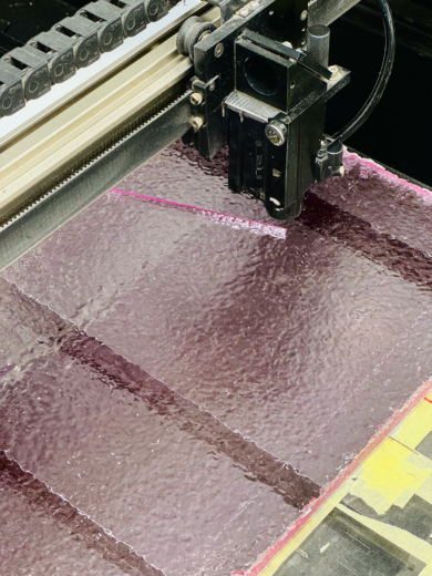 Laser cutting of a sheet of Brut a recycled acrylic from midton's remade range.