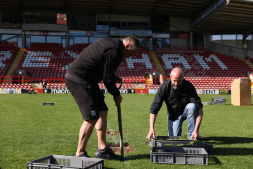Midton team lifting Wrexham AFC pitch turf for authentic football memorabilia gifts