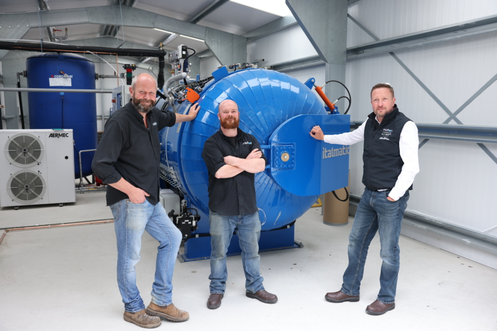 Midton directors standing beside the company’s new large-scale industrial autoclave, a major investment driving innovation and growth.