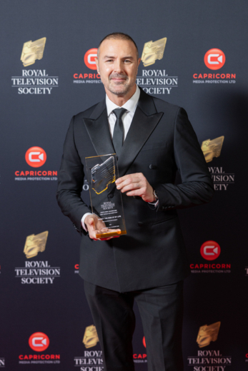 Paddy Mcguinness holding bespoke clear acrylic award at the Royal Television Society Awards, custom manufactured by Midton