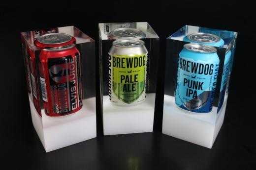 Three BrewDog beer cans including Elvis Juice, Pale Ale and Punk IPA embedded inside premium acrylic blocks with illuminated bases created by Midton.