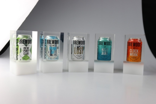 Range of BrewDog beer cans embedded in crystal clear acrylic blocks manufactured by Midton as illuminated hotel room number displays.
