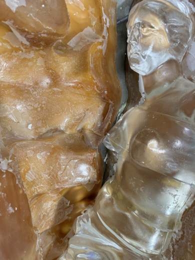 Clear cast acrylic sculpture removed from mould during manufacturing process