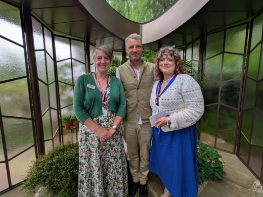 Team standing inside Chelsea Flower Show pavilion surrounded by Midton Remade Brut recycled acrylic panels