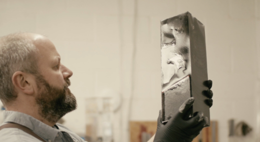 Midton craftsman inspecting a sustainable cast acrylic award during manufacturing in Scotland