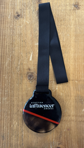 Sustainable acrylic medal created for the Scottish Influencer Awards featuring recycled material design