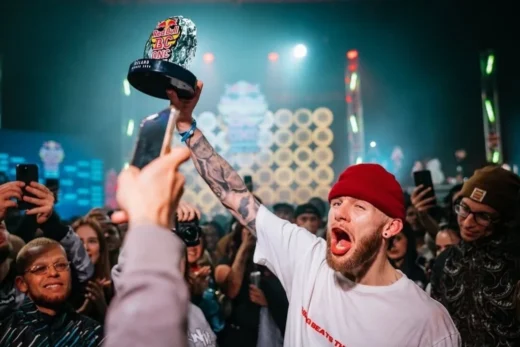 Red Bull BC One winner holding custom acrylic trophy on stage