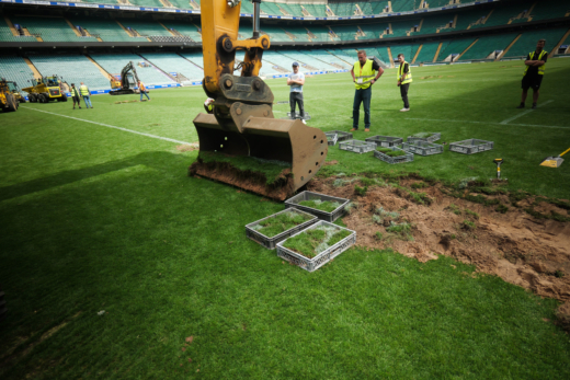Excavator removing the historic Allianz Stadium pitch before Midton preserved sections for official England Rugby memorabilia.