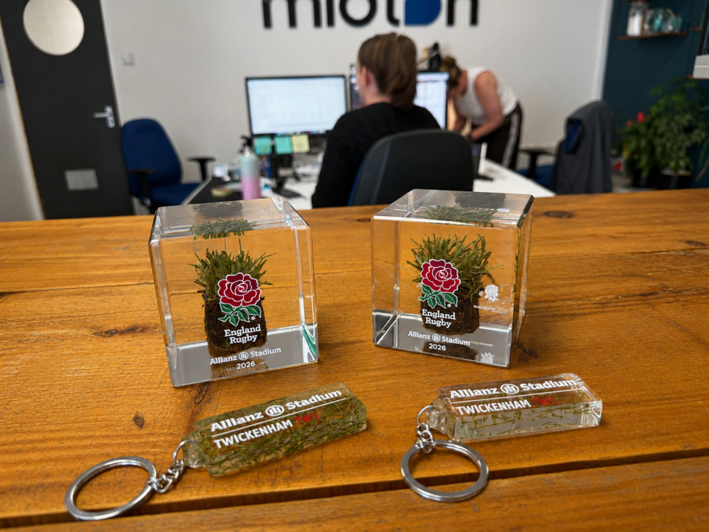 Official England Rugby memorabilia collection featuring genuine Allianz Stadium turf cubes and grass trimming keyrings manufactured by Midton for STIGA and England Rugby.