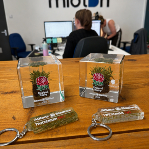 Official England Rugby memorabilia collection featuring genuine Allianz Stadium turf cubes and grass trimming keyrings manufactured by Midton for STIGA and England Rugby.
