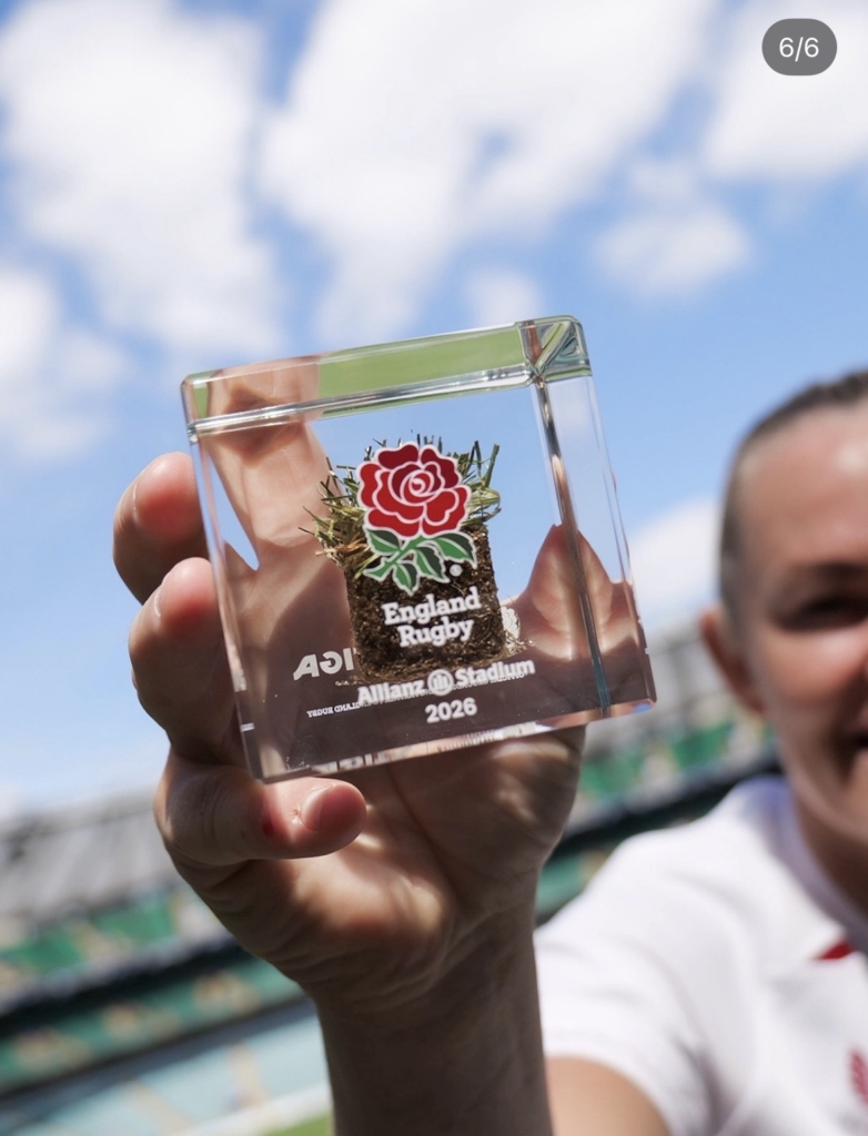 Close-up of an official England Rugby turf memorabilia cube made from authentic Allianz Stadium grass and preserved in acrylic by Midton.