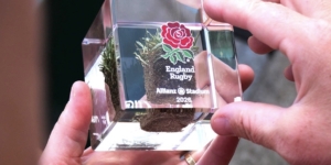Close-up of the official England Rugby turf cube containing genuine Allianz Stadium grass preserved in acrylic.