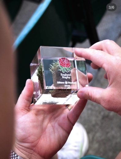 Close-up of the official England Rugby turf cube containing genuine Allianz Stadium grass preserved in acrylic.
