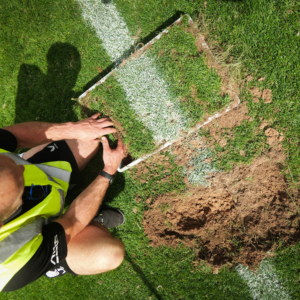 Midton carefully selecting authentic touchline turf from Allianz Stadium to preserve iconic England Rugby match markings within premium acrylic memorabilia.