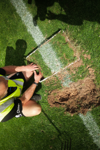Midton carefully selecting authentic touchline turf from Allianz Stadium to preserve iconic England Rugby match markings within premium acrylic memorabilia.