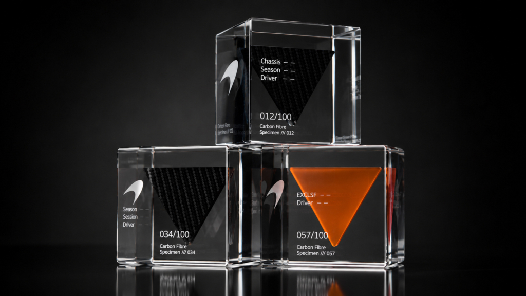 Limited edition carbon fibre motorsport specimens displayed inside numbered acrylic Legacy Cubes