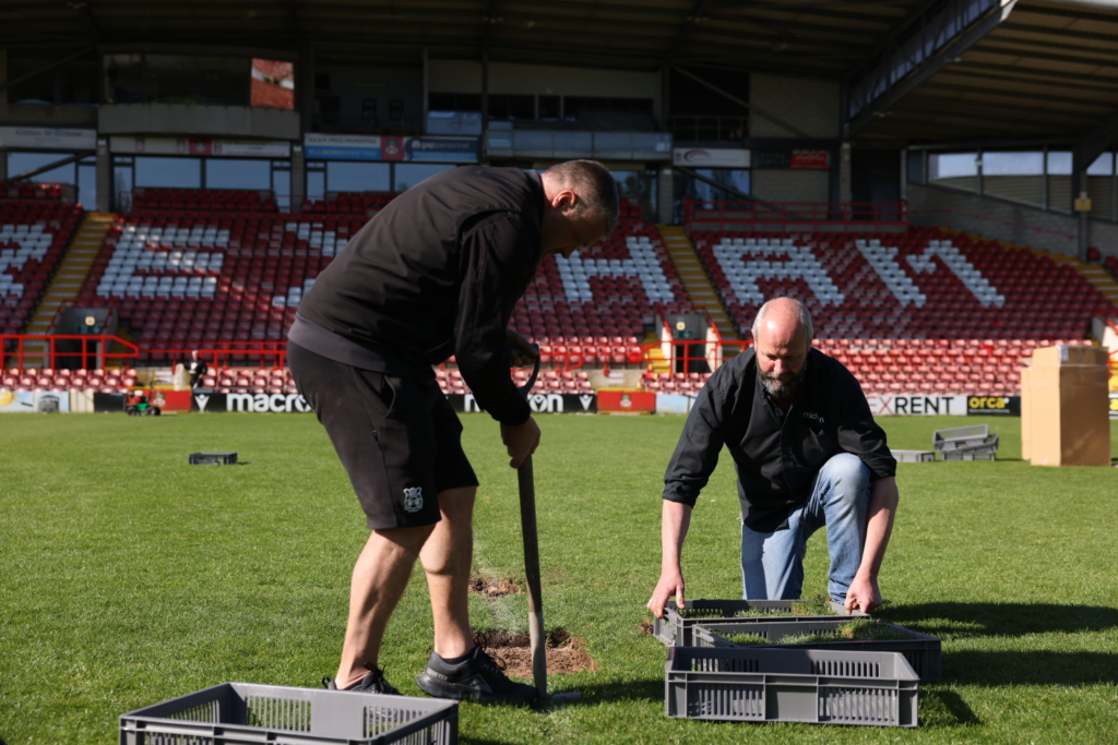 Wrexham AFC stadium turf being collected for preservation in custom acrylic memorabilia