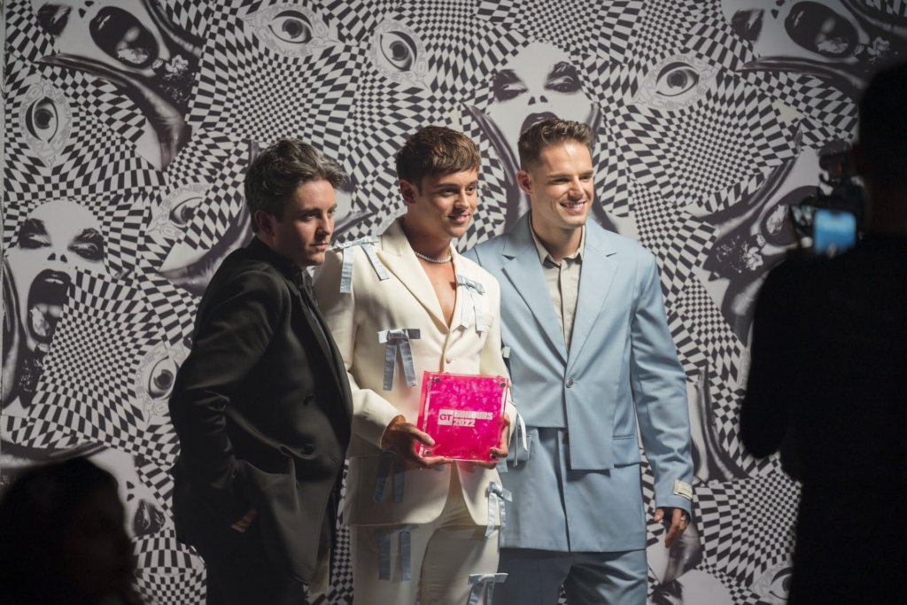 Gay Times Honours 2022 recipient holding the bespoke pink acrylic award